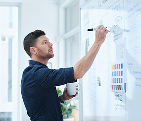 Person writing on a white board