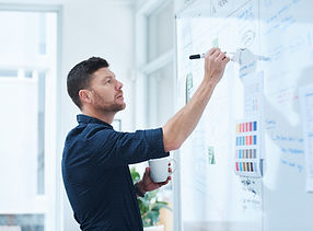 Person writing on a white board 2