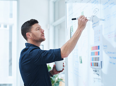 Person writing on white board
